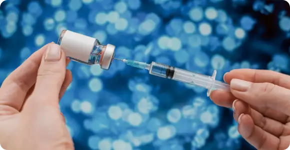 A healthcare professional preparing a personalized peptide therapy treatment to support cellular optimization and immune modulation as part of a longevity care plan.