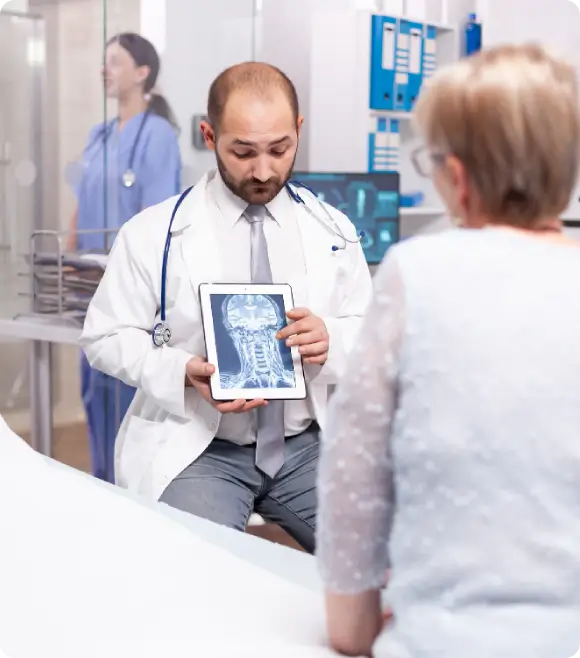 A medical consultation at The Vitality Medical and Longevity Center focusing on preventative neurodegenerative care and upper cervical optimization for vagus nerve health.