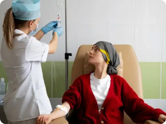 Nurse preparing an IV drip for a patient wearing a headscarf, illustrating supportive treatment for conditions requiring structural repair like stroke recovery or neuropathy.